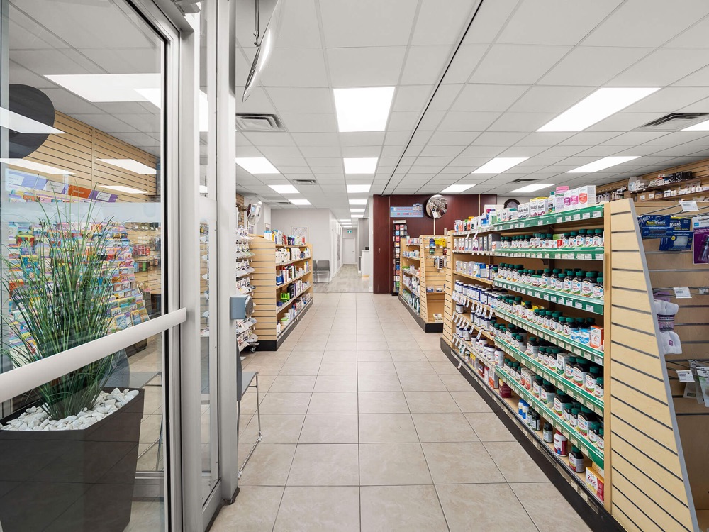 Marcos Pharmacy interior aisle stocked with medications and wellness products